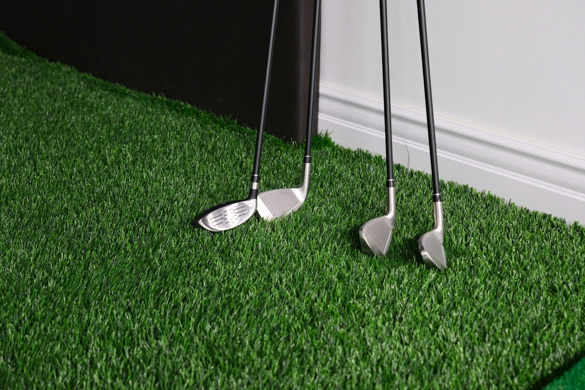 A pair of golf clubs sitting on top of a green field