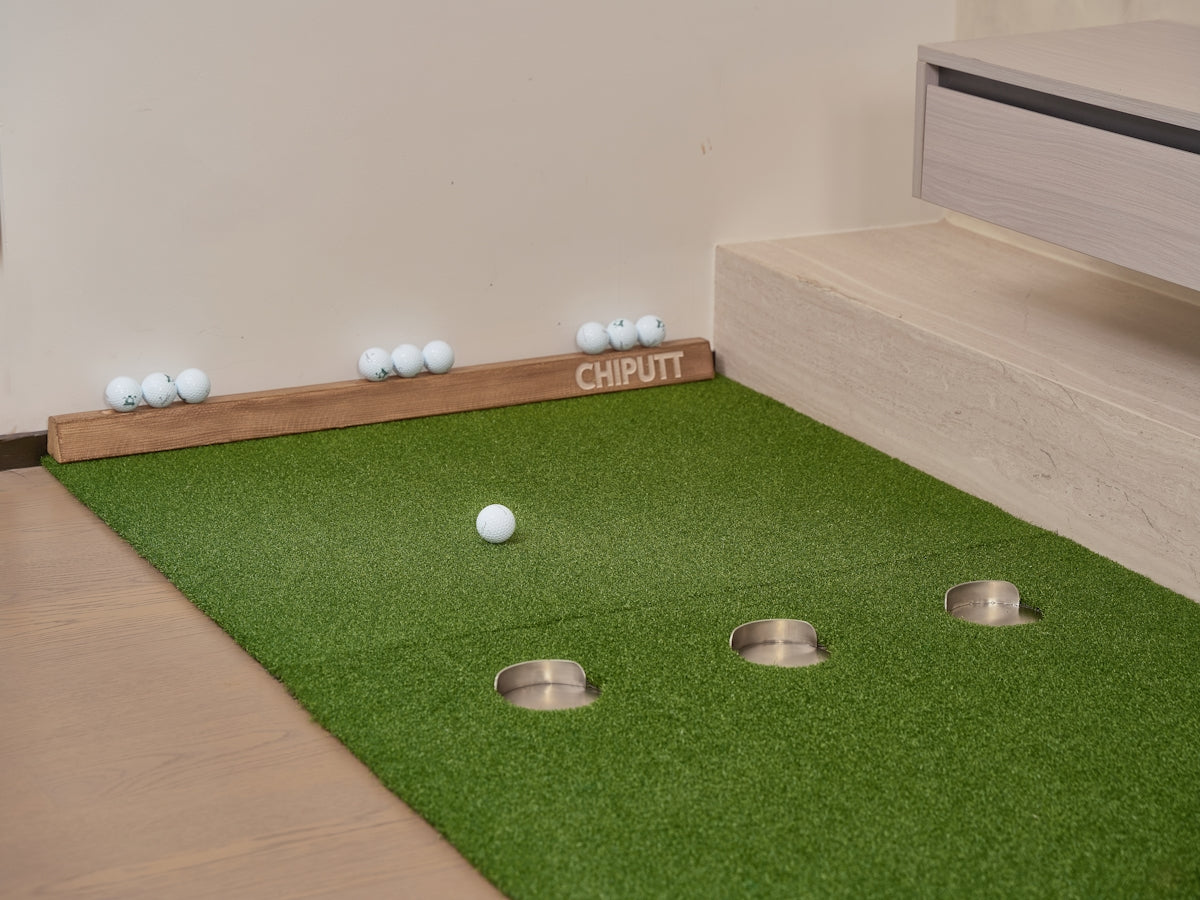 Golf putting green with balls and holes