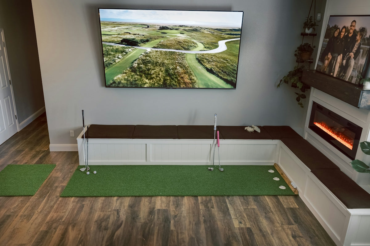 Indoor putting green with golf on television screen
