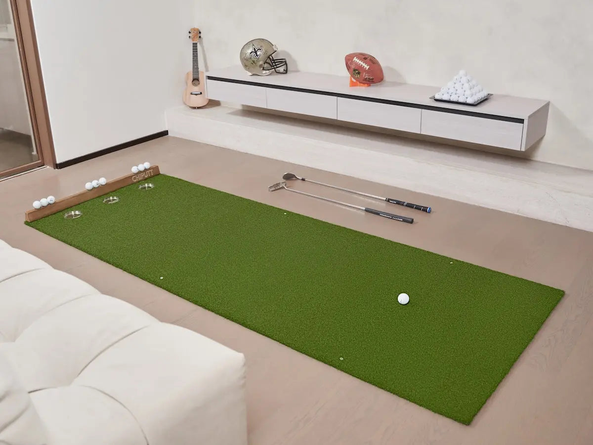 Golf putting green with putter and ball indoors.