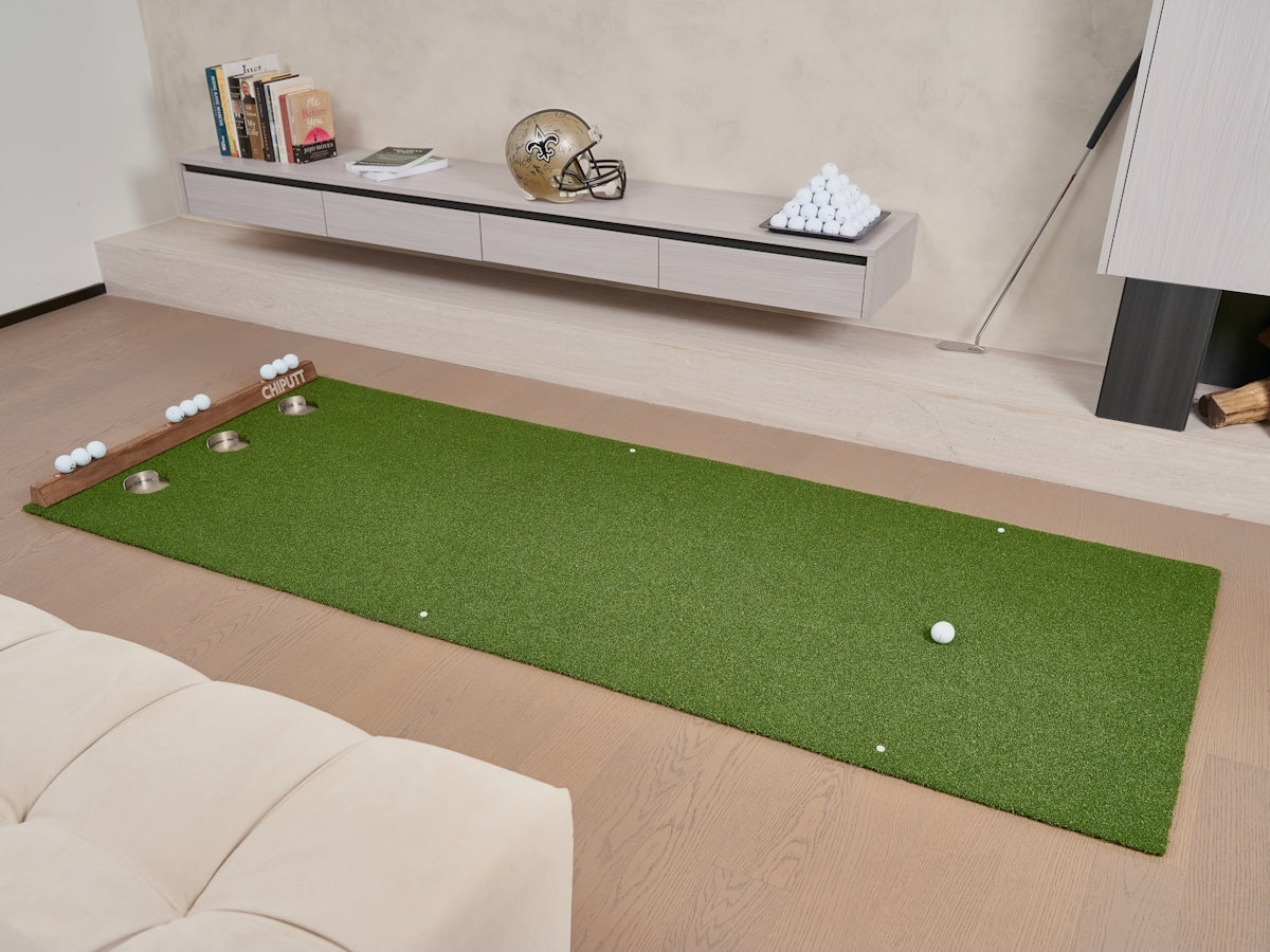 Indoor putting green with golf balls and clubs