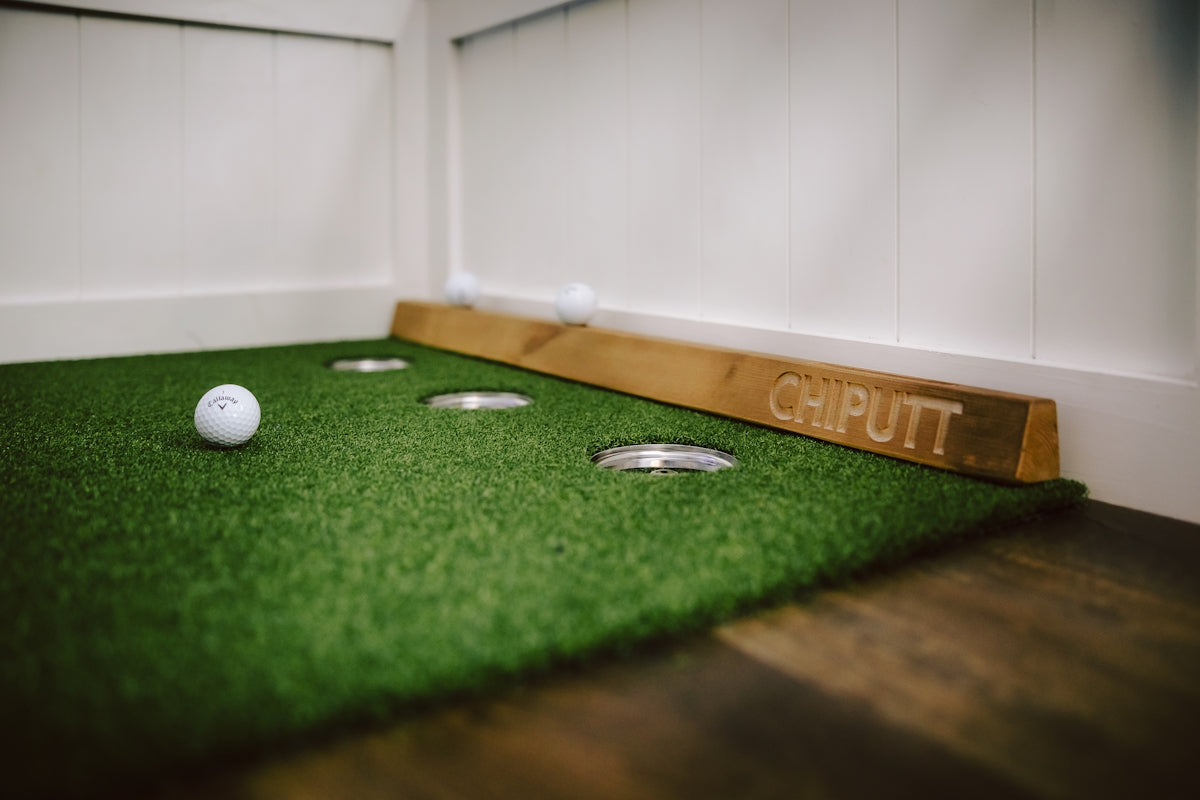 Indoor putting green with golf ball and cups