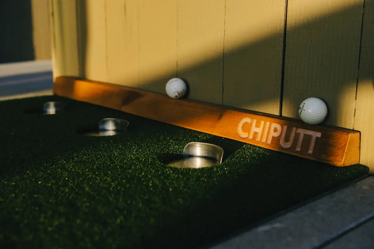 Golf balls on a mini-golf course with holes.