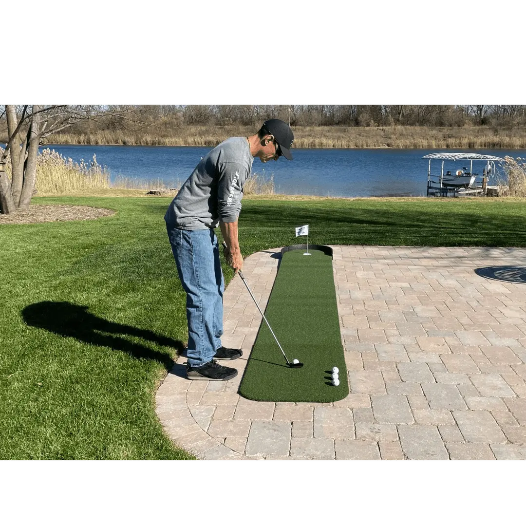 Person putting with four golf balls on Big Moss Commander Patio Series 215 Putting Chipping Green