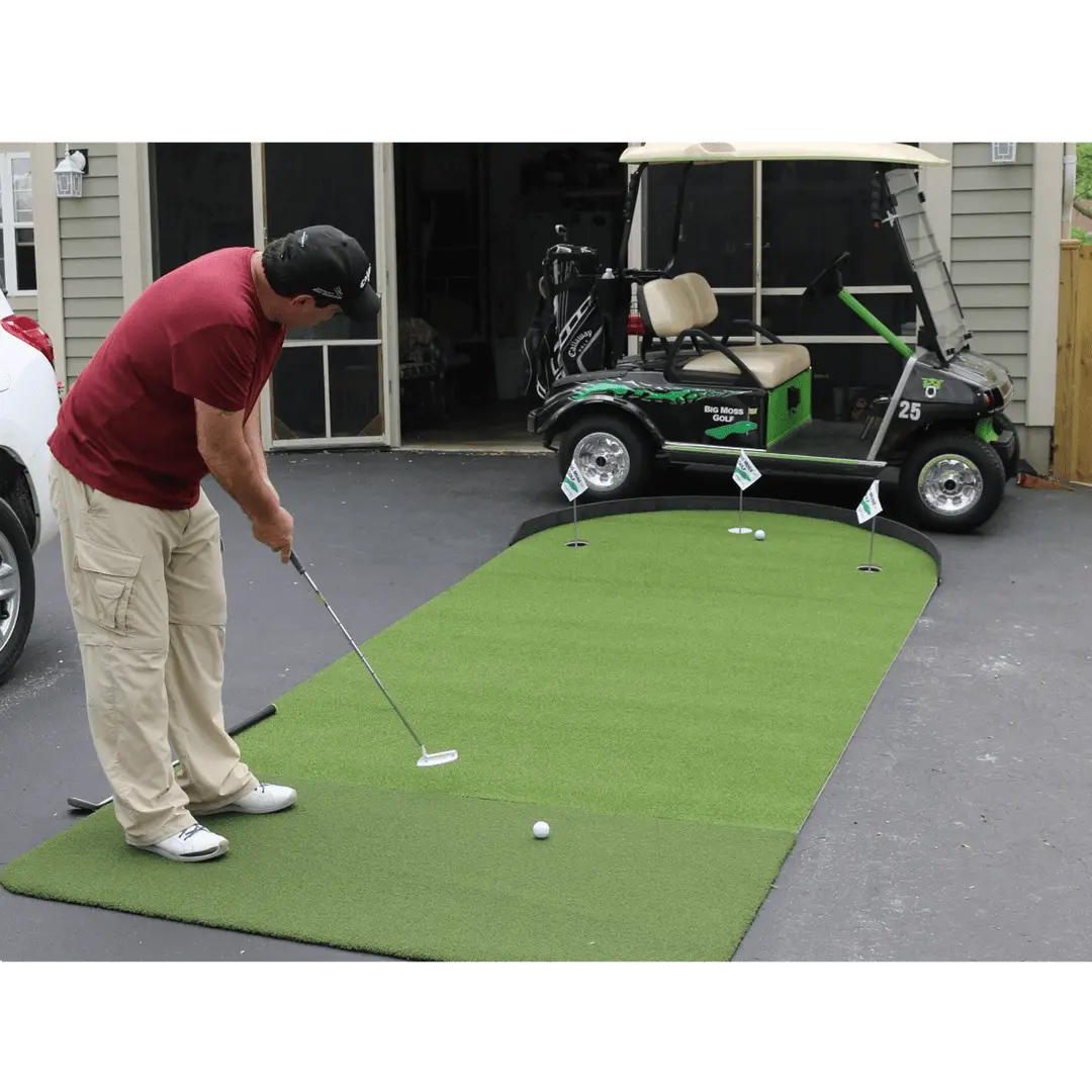 Man putting on a Big Moss Commander Patio Series 615 Green in driveway, cart and garage visible in background