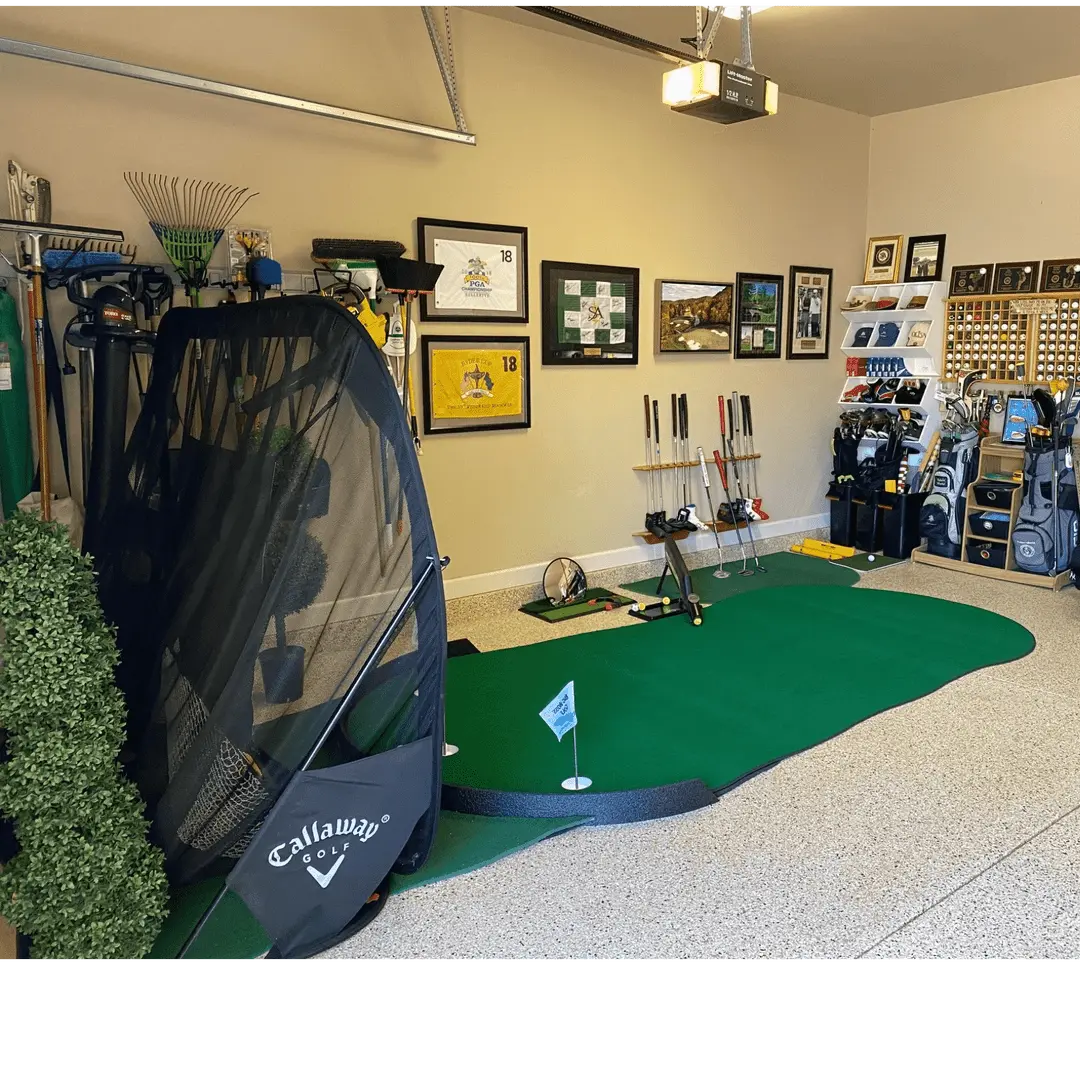 Indoor golf space with Big Moss The General Putting Green, practice mat, golf bags, clubs, and sports memorabilia visible