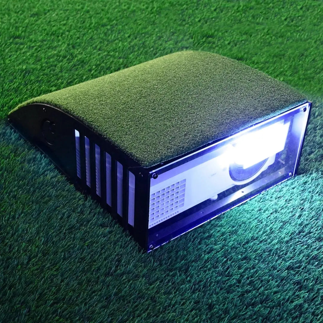 Floor mounted projector enclosure shown placed on grass