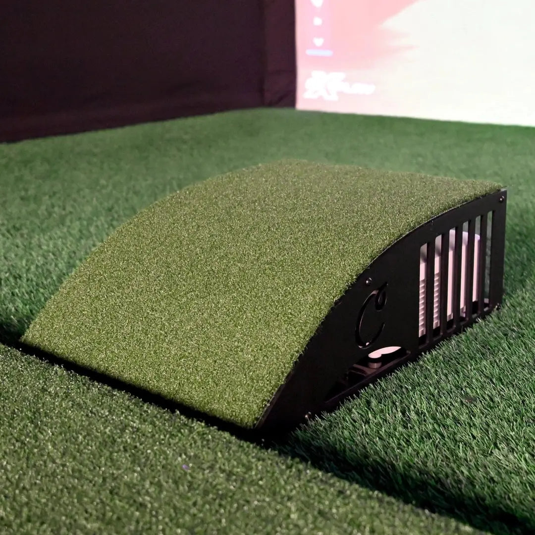 Curved green floor mounted projector enclosure with black slotted sides, designed for projector protection