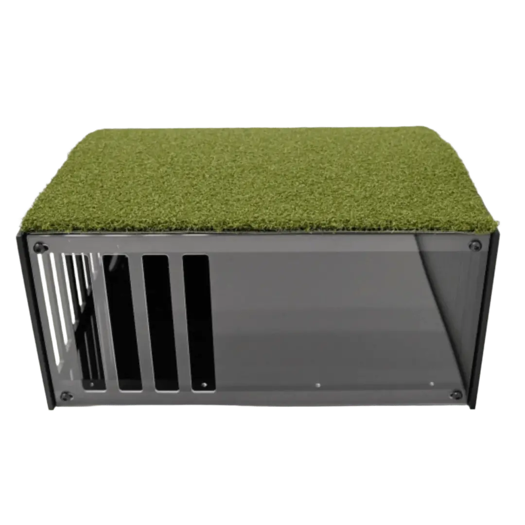 Floor mounted projector enclosure, black rectangular box with a transparent side and green grass covering the top.