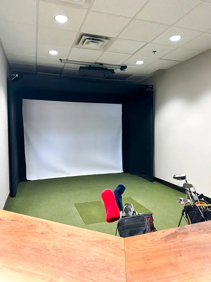The SportScreen Parlour 11 golf simulator enclosure view from behind a bar view