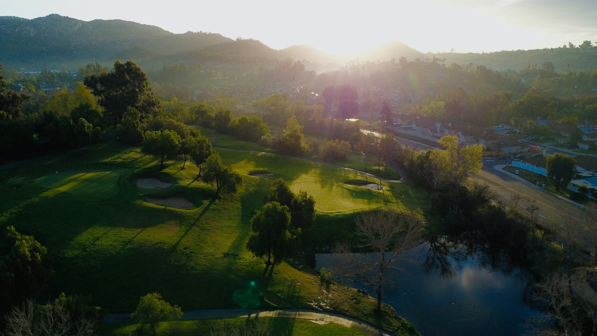 Sunset shines over a lush golf course