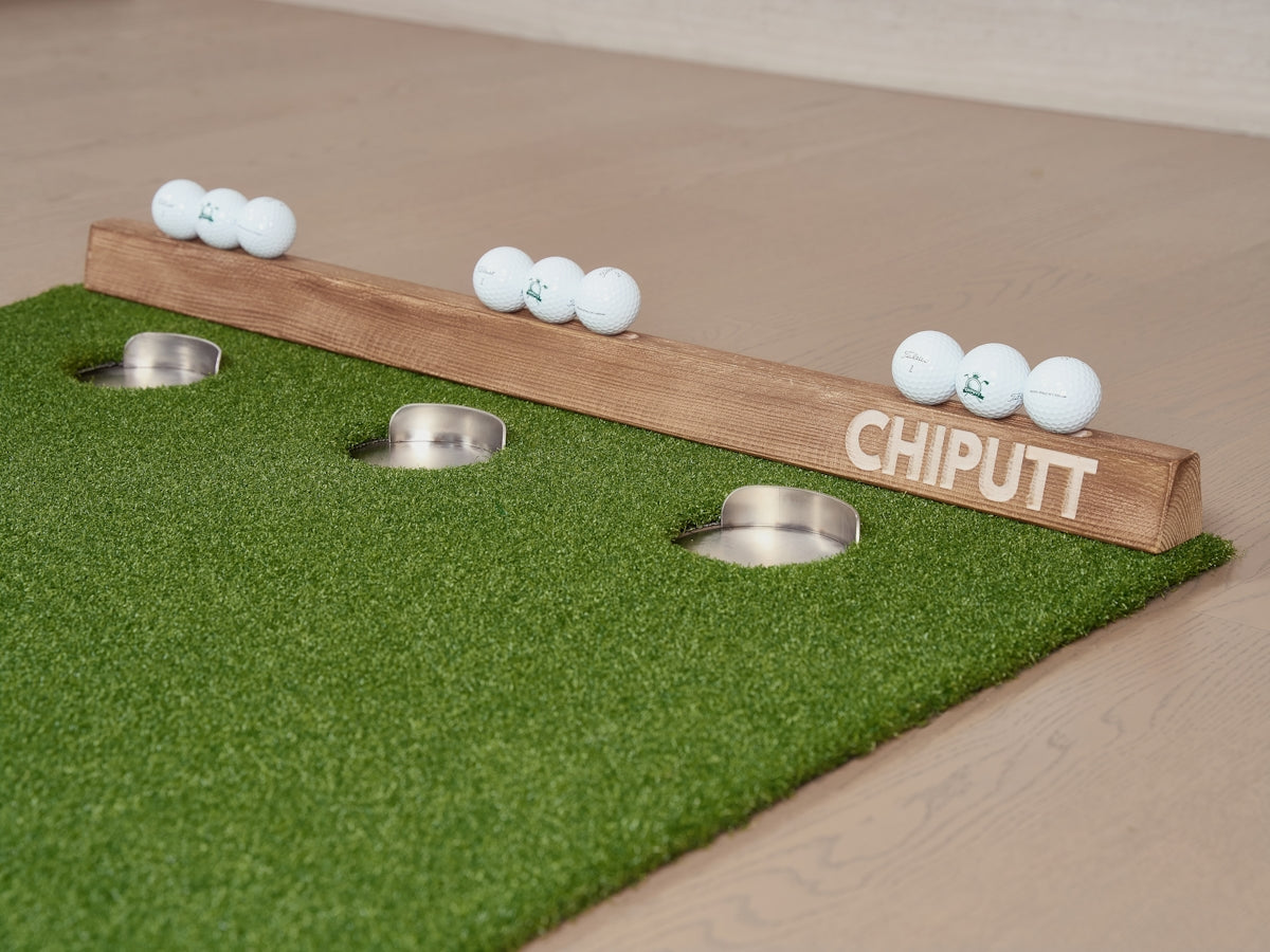 Golf chipping practice mat with balls and cups