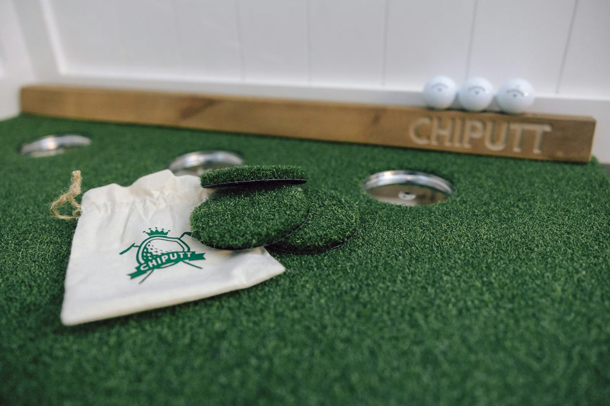 Golf putting green with balls and practice mat