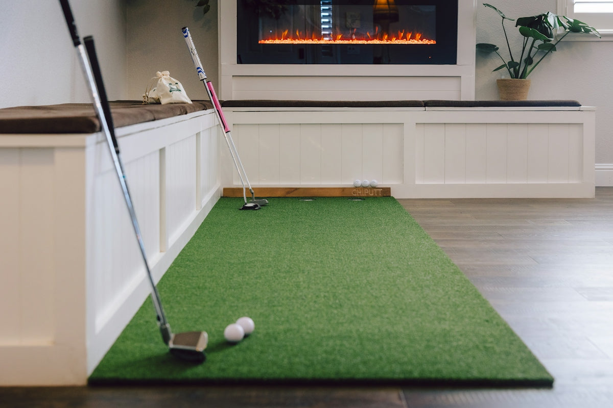 Indoor putting green with golf clubs and balls