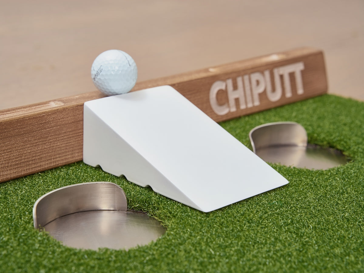Golf chipping practice setup with ball and ramp