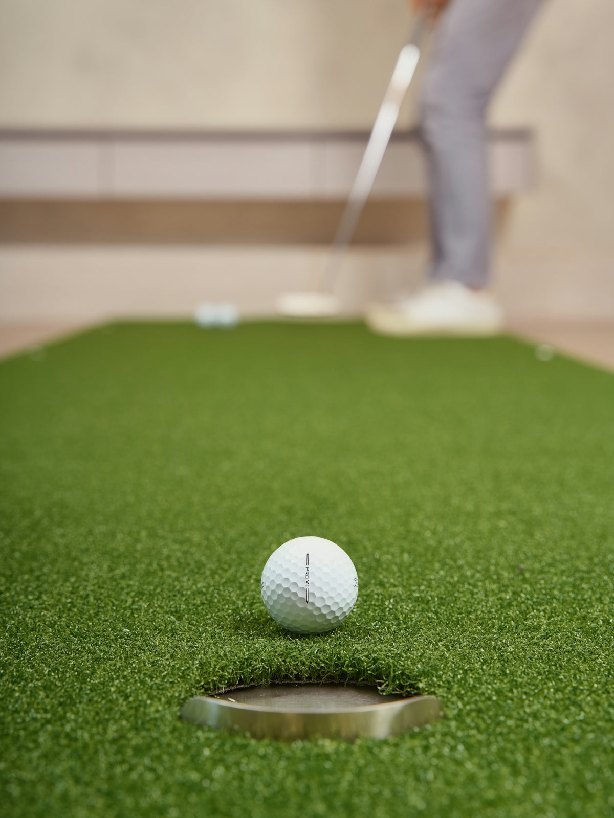 Golfer putting a ball on a green